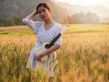 Young woman standing on field