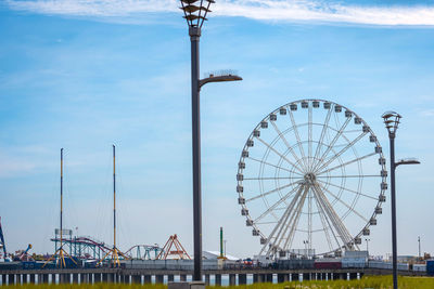 Ferris wheel in city against sky