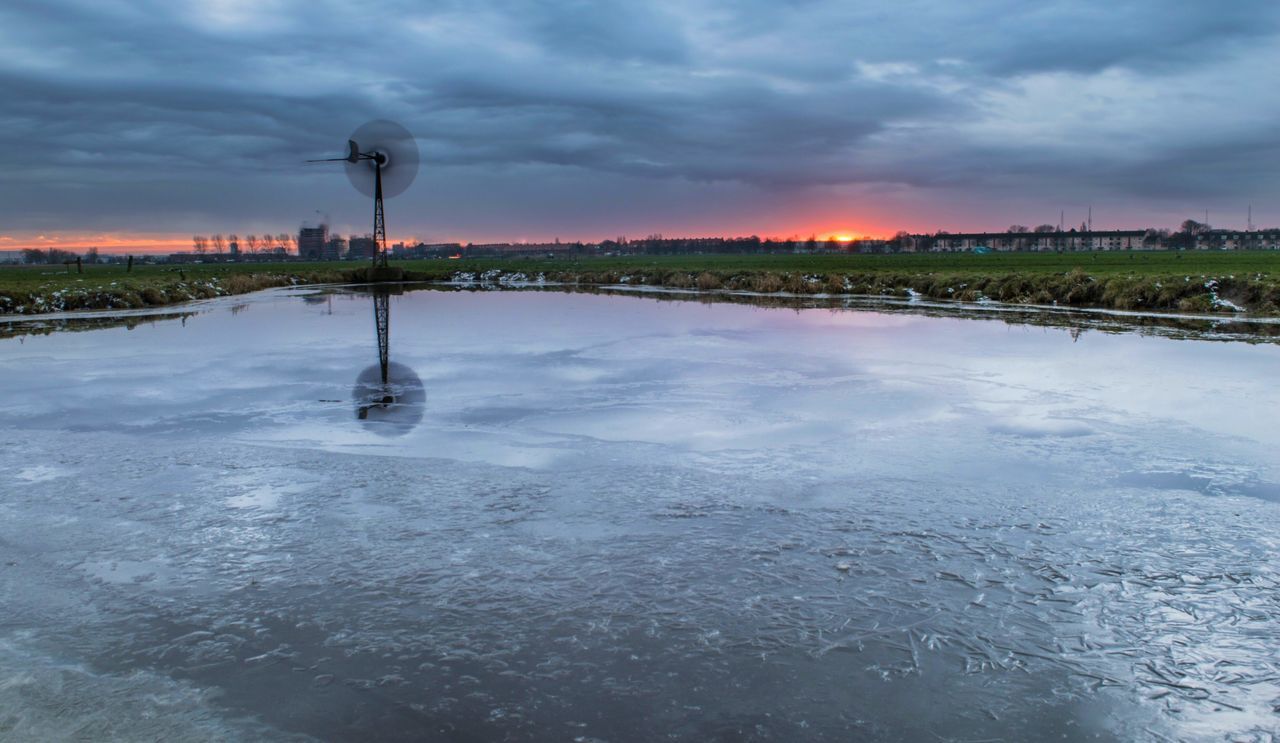 water, sky, cloud - sky, cloudy, weather, reflection, waterfront, cloud, nature, built structure, scenics, tranquility, tranquil scene, lake, river, beauty in nature, overcast, architecture, outdoors, building exterior