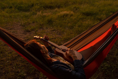 A european woman in a hammock in on the sunset.  camping