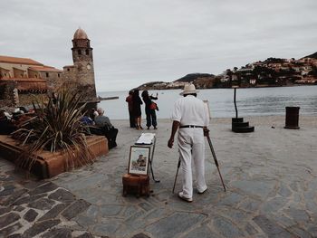 Man standing by sea against sky