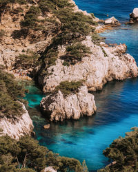 High angle view of rocks on sea shore