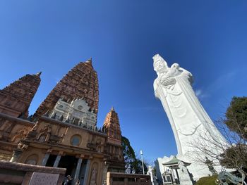 Low angle view of historical building against blue sky