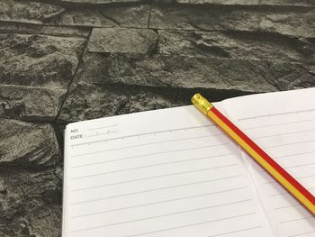 High angle view of pencil and book on table