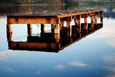 Reflection of boat in lake against sky