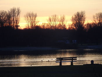 Scenic view of lake against sky during sunset