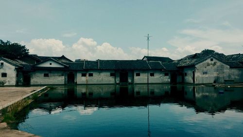 Houses against cloudy sky