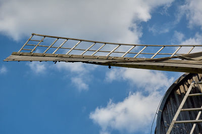 Low angle view of crane against sky