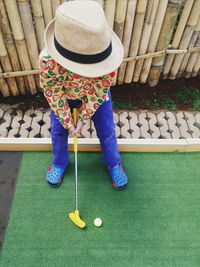 High angle view of boy playing golf in yard