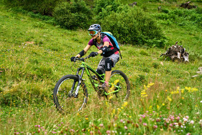 Bicycle riding motorcycle on field