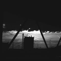 Silhouette buildings against cloudy sky