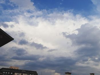 Low angle view of building against cloudy sky