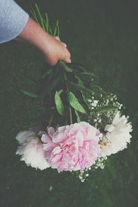 Close-up of hand holding flowers