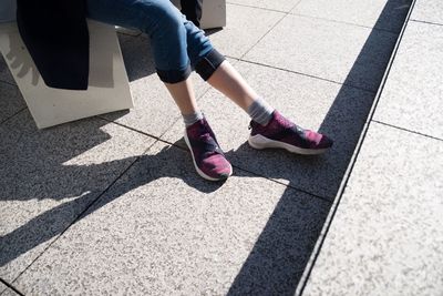 Low section of woman standing on tiled floor