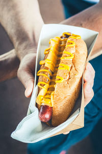 Cropped hand of man holding food