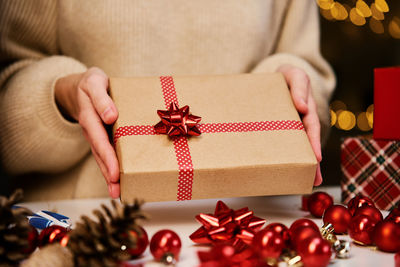 Woman holding gift box in hands. surprise for winter holidays