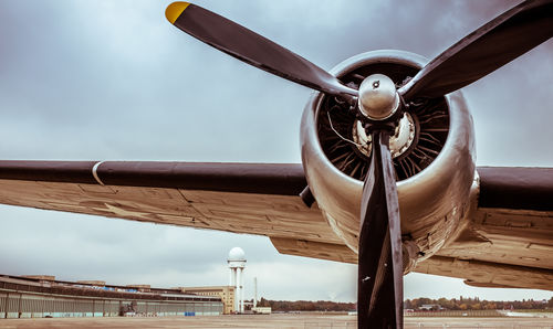 Military airplane at berlin tempelhof airport against sky