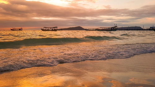 Scenic view of beach against sky during sunset