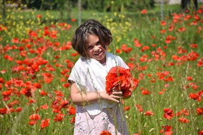 Side view of young woman holding flowers