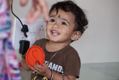 Portrait of a smiling girl holding camera