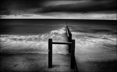 Lifeguard hut on beach against sky