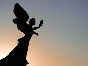 Silhouette of a statue at sunset in rome