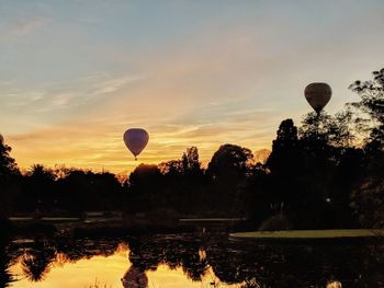Silhouette of hot air balloon against sky during sunset