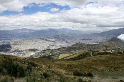 Scenic view of mountains against cloudy sky