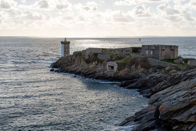 Scenic view of a lighthouse at the end of a rocky point