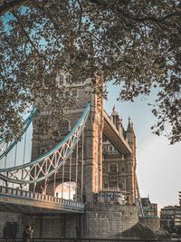 Low angle view of bridge and buildings against sky