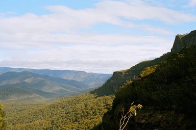 Scenic view of mountains against cloudy sky