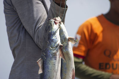 Close-up of man holding fish