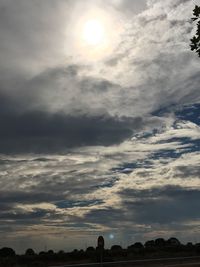 Silhouette landscape against cloudy sky