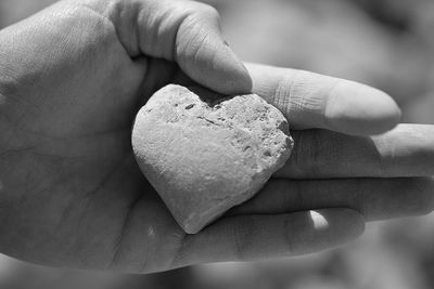 Close-up of hand holding heart shape