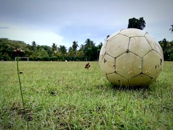 Close-up of soccer on field against sky