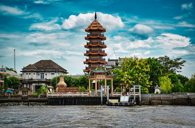 Buildings with traditional thai architecture on the bank of the chao phraya river