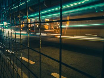 Light trails on railroad station platform at night