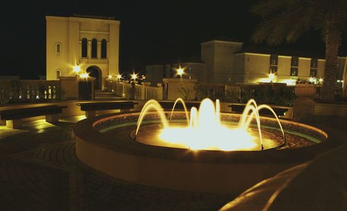 Lit candle in dark room