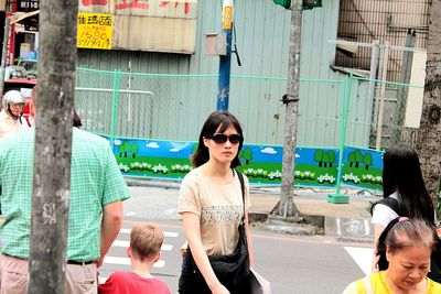 Portrait of woman standing in city