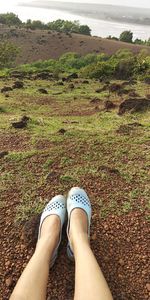 Low section of woman resting on field