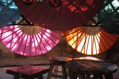 Low angle view of illuminated lanterns hanging on table in restaurant