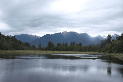 Scenic view of lake and mountains against sky