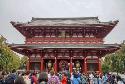 People standing outside temple 