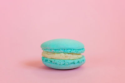 Close-up of multi colored candies against pink background