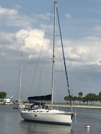 Boats sailing in sea against sky