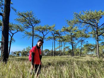 Man standing on field against sky