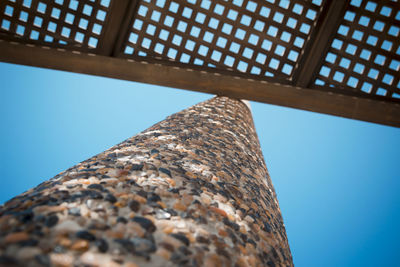 Low angle view of metallic structure against blue sky