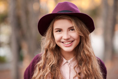 Portrait of happy woman wearing hat