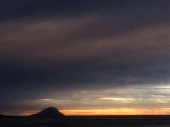 Scenic view of dramatic sky over silhouette landscape