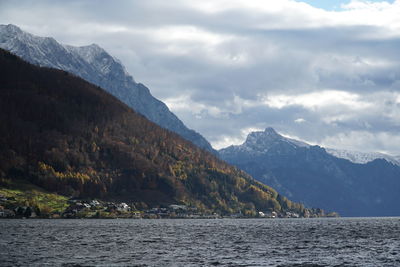 Scenic view of sea and mountains against sky. sturmiger traunsee.